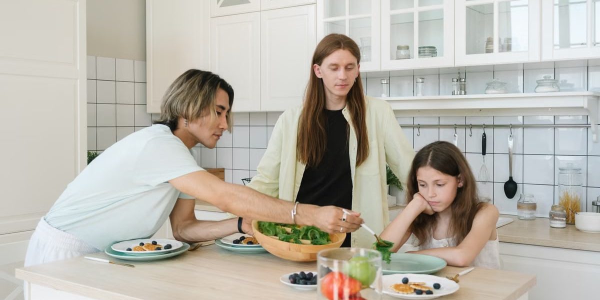A diverse family enjoys meal preparation and bonding in a stylish kitchen setting.