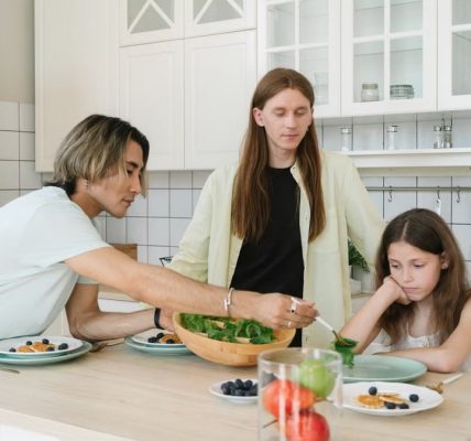 A diverse family enjoys meal preparation and bonding in a stylish kitchen setting.