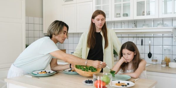 A diverse family enjoys meal preparation and bonding in a stylish kitchen setting.